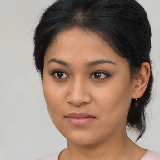 Joyful latino young-adult female with medium  brown hair and brown eyes