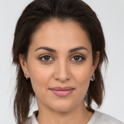 Joyful white young-adult female with medium  brown hair and brown eyes