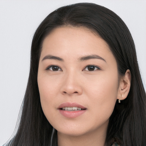 Joyful asian young-adult female with long  brown hair and brown eyes