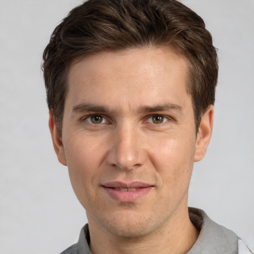 Joyful white adult male with short  brown hair and grey eyes