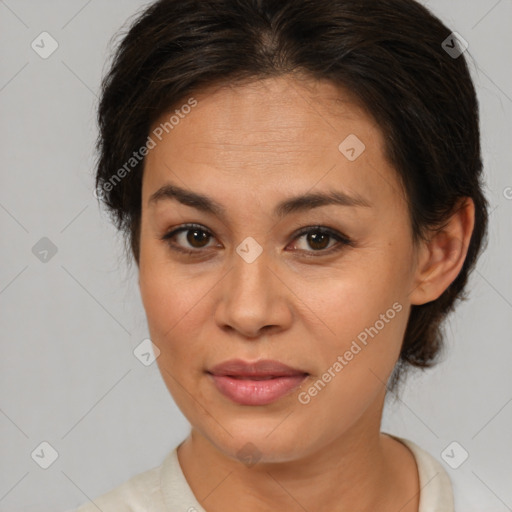 Joyful latino adult female with medium  brown hair and brown eyes