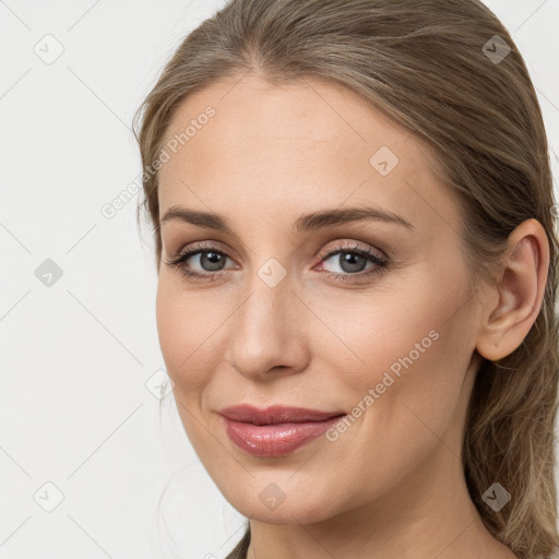 Joyful white young-adult female with long  brown hair and grey eyes