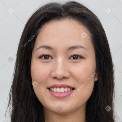 Joyful asian young-adult female with long  brown hair and brown eyes