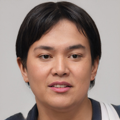 Joyful asian young-adult female with short  brown hair and brown eyes