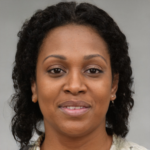 Joyful black young-adult female with medium  brown hair and brown eyes