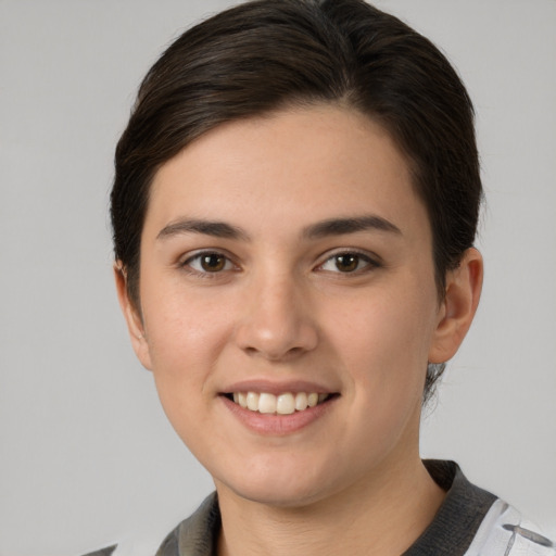 Joyful white young-adult female with medium  brown hair and brown eyes