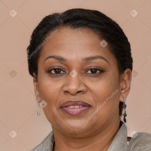 Joyful black adult female with short  brown hair and brown eyes