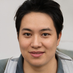 Joyful asian young-adult male with short  brown hair and brown eyes