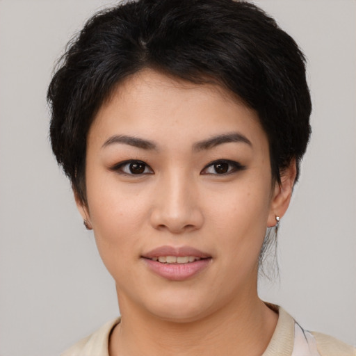 Joyful asian young-adult female with short  black hair and brown eyes