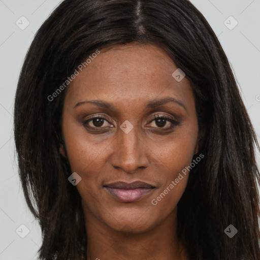 Joyful black adult female with long  brown hair and brown eyes