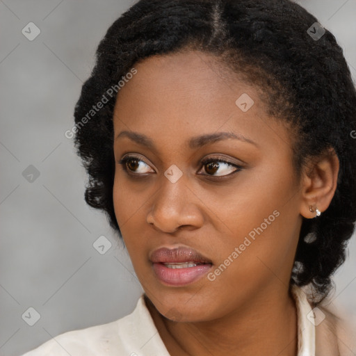 Joyful black young-adult female with medium  black hair and brown eyes