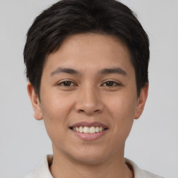 Joyful asian young-adult male with short  brown hair and brown eyes