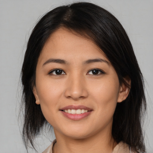 Joyful asian young-adult female with medium  brown hair and brown eyes