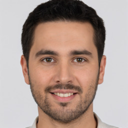 Joyful white young-adult male with short  brown hair and brown eyes