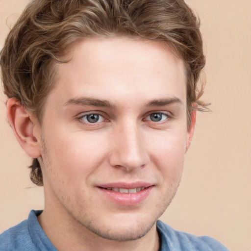 Joyful white young-adult male with short  brown hair and blue eyes