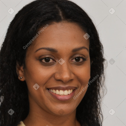 Joyful black young-adult female with long  brown hair and brown eyes