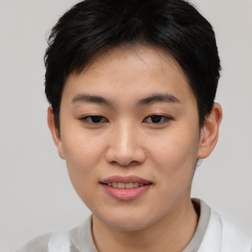 Joyful asian young-adult female with short  brown hair and brown eyes