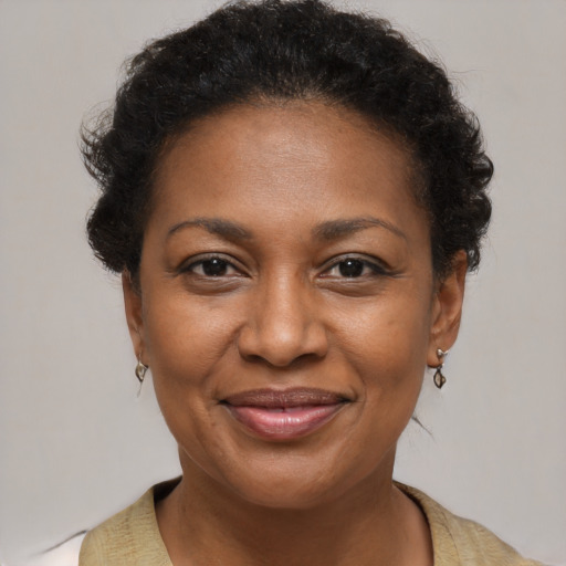 Joyful black adult female with short  brown hair and brown eyes