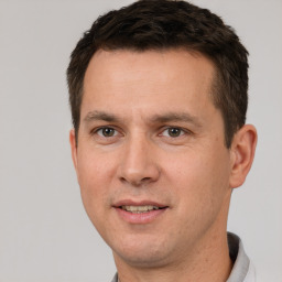 Joyful white young-adult male with short  brown hair and brown eyes