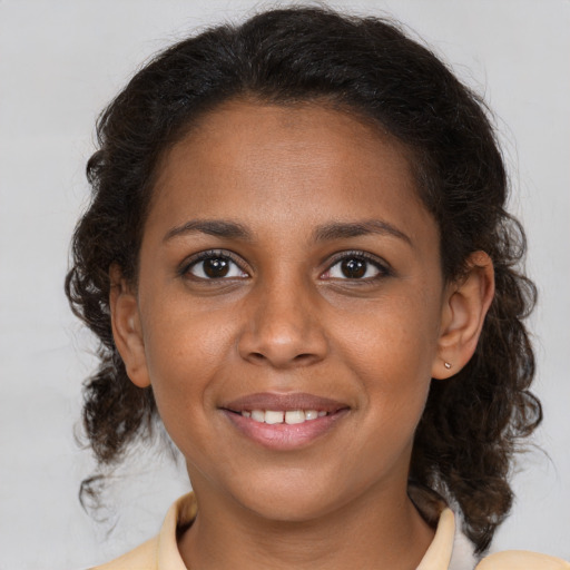 Joyful black young-adult female with medium  brown hair and brown eyes