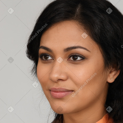 Joyful latino young-adult female with medium  brown hair and brown eyes