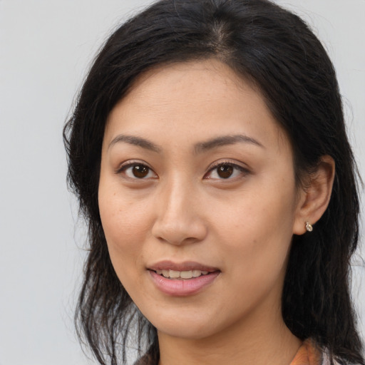 Joyful asian young-adult female with long  brown hair and brown eyes