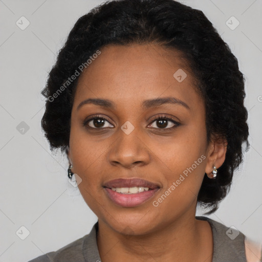 Joyful black young-adult female with long  black hair and brown eyes