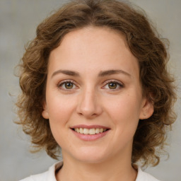 Joyful white young-adult female with medium  brown hair and green eyes