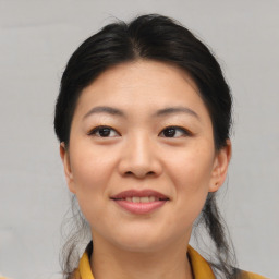 Joyful asian young-adult female with medium  black hair and brown eyes