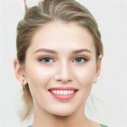 Joyful white young-adult female with medium  brown hair and green eyes