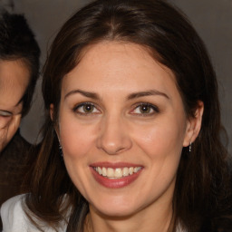 Joyful white young-adult female with medium  brown hair and brown eyes