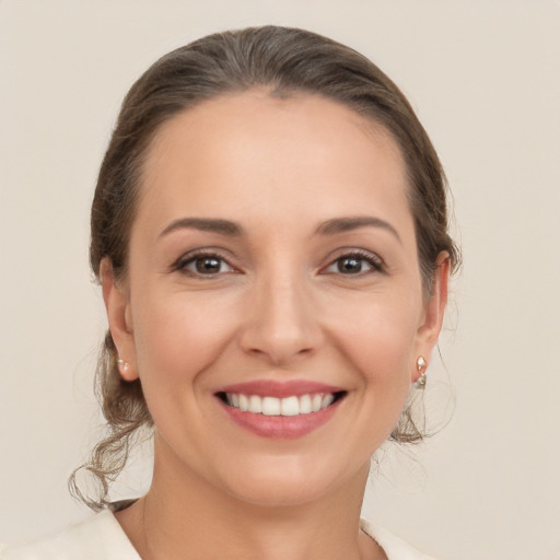 Joyful white young-adult female with medium  brown hair and brown eyes