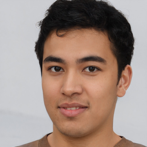 Joyful asian young-adult male with short  brown hair and brown eyes
