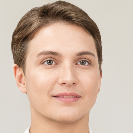 Joyful white young-adult female with short  brown hair and grey eyes