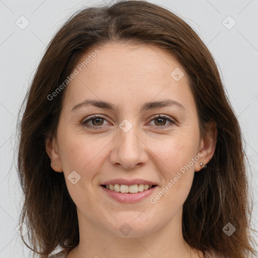 Joyful white adult female with long  brown hair and brown eyes