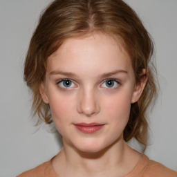 Joyful white child female with medium  brown hair and brown eyes