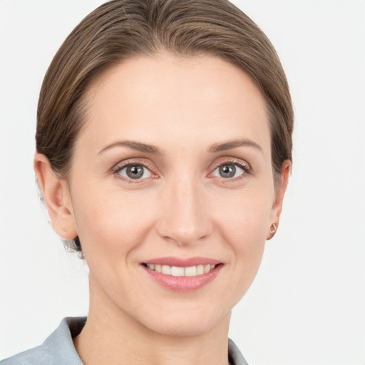 Joyful white young-adult female with medium  brown hair and grey eyes