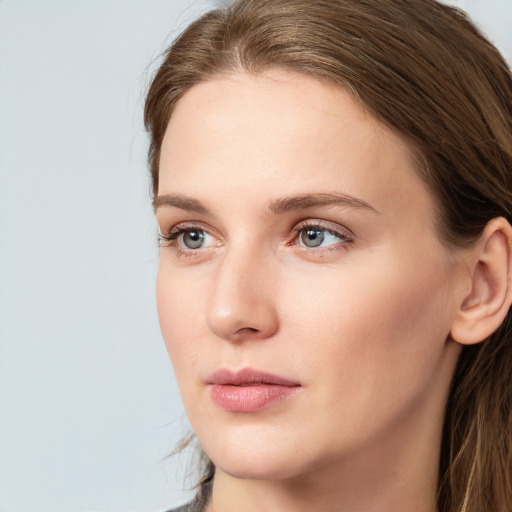 Neutral white young-adult female with long  brown hair and blue eyes