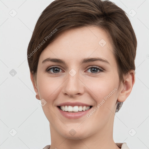 Joyful white young-adult female with short  brown hair and grey eyes