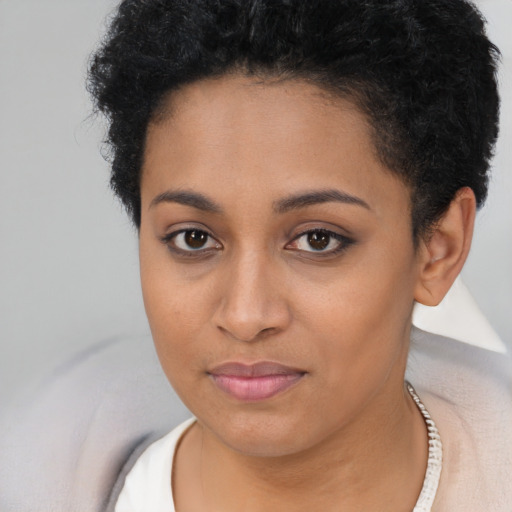 Joyful latino young-adult female with short  brown hair and brown eyes