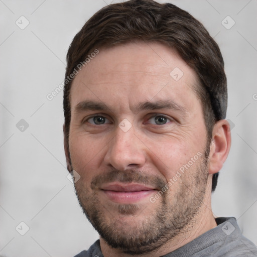 Joyful white adult male with short  brown hair and grey eyes