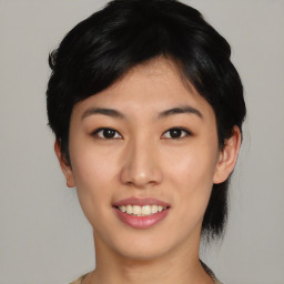 Joyful asian young-adult female with short  black hair and brown eyes