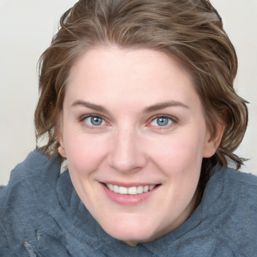 Joyful white young-adult female with medium  brown hair and blue eyes