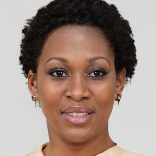 Joyful black young-adult female with short  brown hair and brown eyes