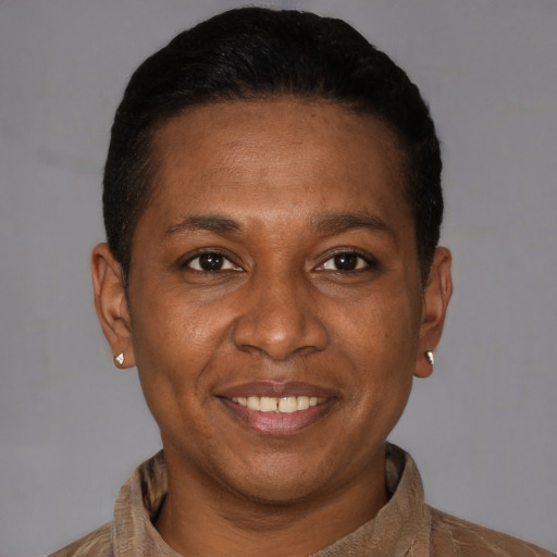 Joyful black adult male with short  brown hair and brown eyes
