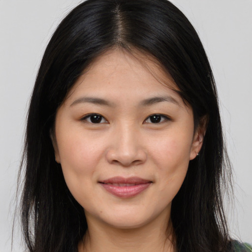 Joyful asian young-adult female with long  brown hair and brown eyes