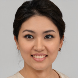 Joyful asian young-adult female with medium  brown hair and brown eyes