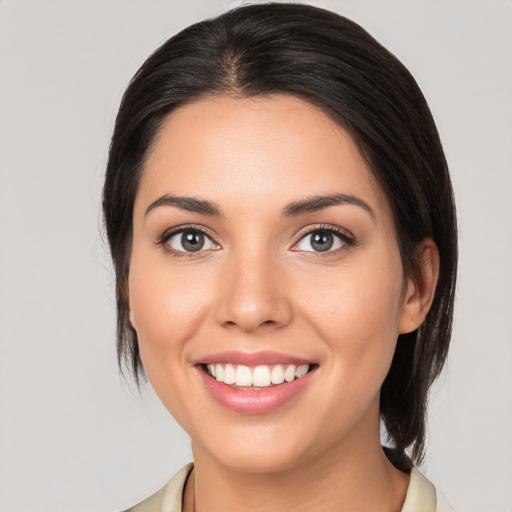 Joyful white young-adult female with medium  brown hair and brown eyes