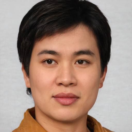 Joyful asian young-adult male with short  brown hair and brown eyes