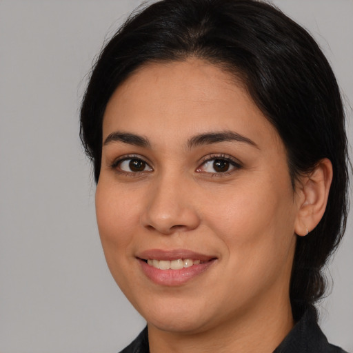 Joyful latino young-adult female with medium  brown hair and brown eyes